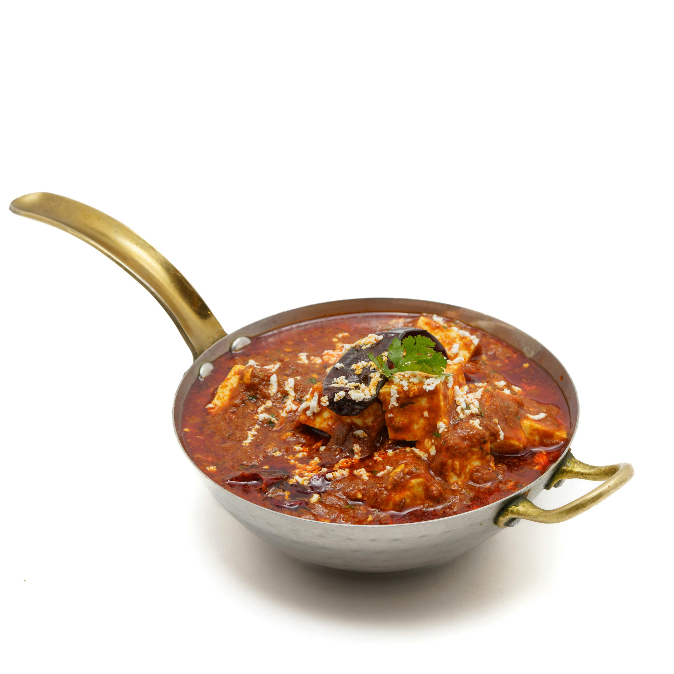 A delicious, spicy Indian curry served in a traditional brass pan, rich in vibrant colors and aroma.